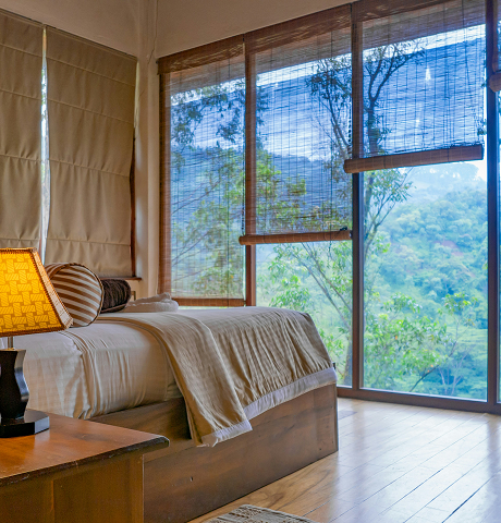 A serene Deepsky Villa bedroom overlooking the tropical landscape