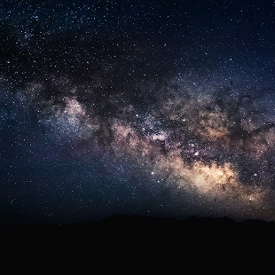 The Milky Way stretching above a dark horizon