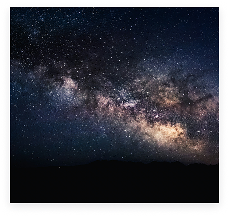 The Milky Way above a dark mountain horizon