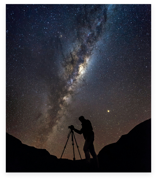 An astrophotographer working beneath the Milky Way