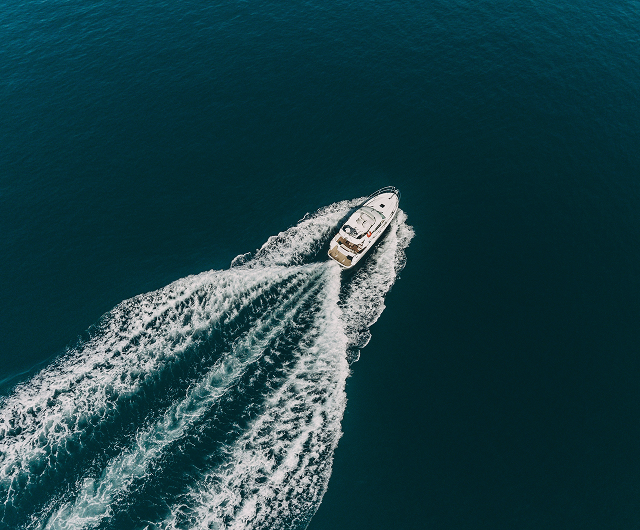 A speedboat crossing deep blue water