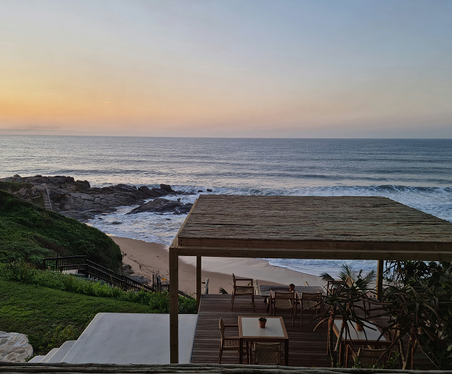 Oceanfront terrace overlooking the beach at sunset